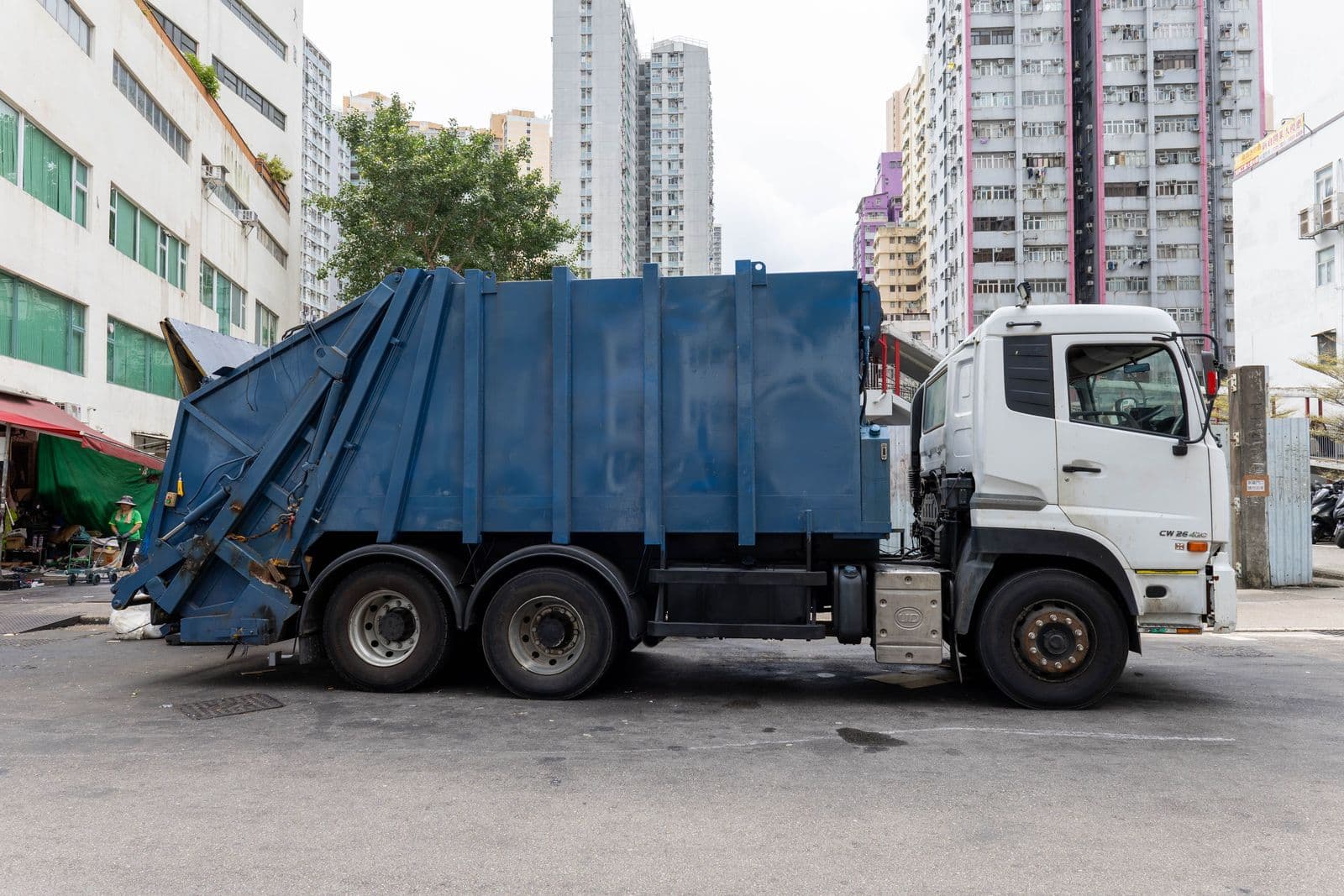 A refuse collection truck working a city street